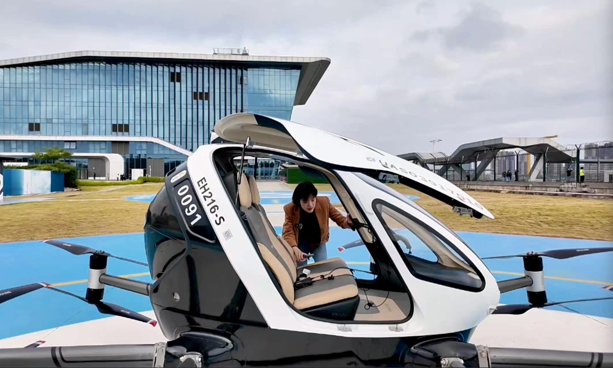 A Global Times reporter experiences the EH216?S manned eVTOL aircraft at a flight base of Guangzhou Suigang Ferry Terminal in Guangzhou Development District. Photo: Chen Zishuai/GT