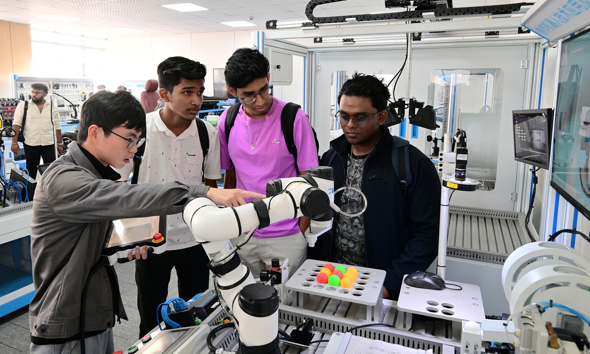 Students from Malaysia visit an electronic technology company in Jinhua, East China's Zhejiang Province, to learn about the application and innovation of collaborative robot technology on November 7, 2025. Photo: VCG