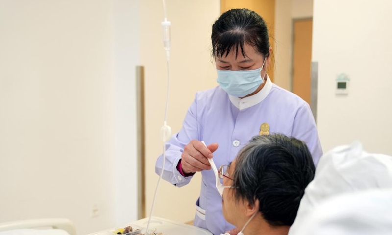 A nursing assistant feeds an inpatient at a hospital in Shanghai, east China, Feb. 26, 2026.(Xinhua/Liu Ying)