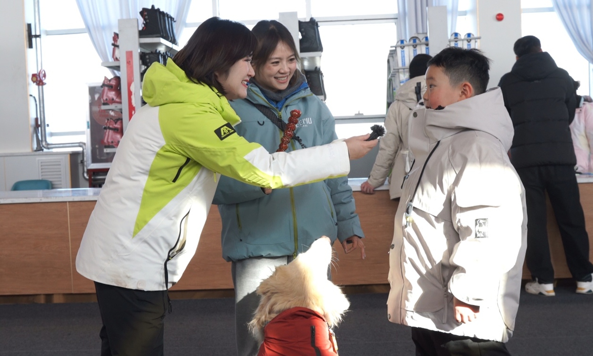 Kong Feifei, a deputy to the NPC and Deputy General Manager of Ili Cultural Tourism Industry Group Co. Ltd. (left)