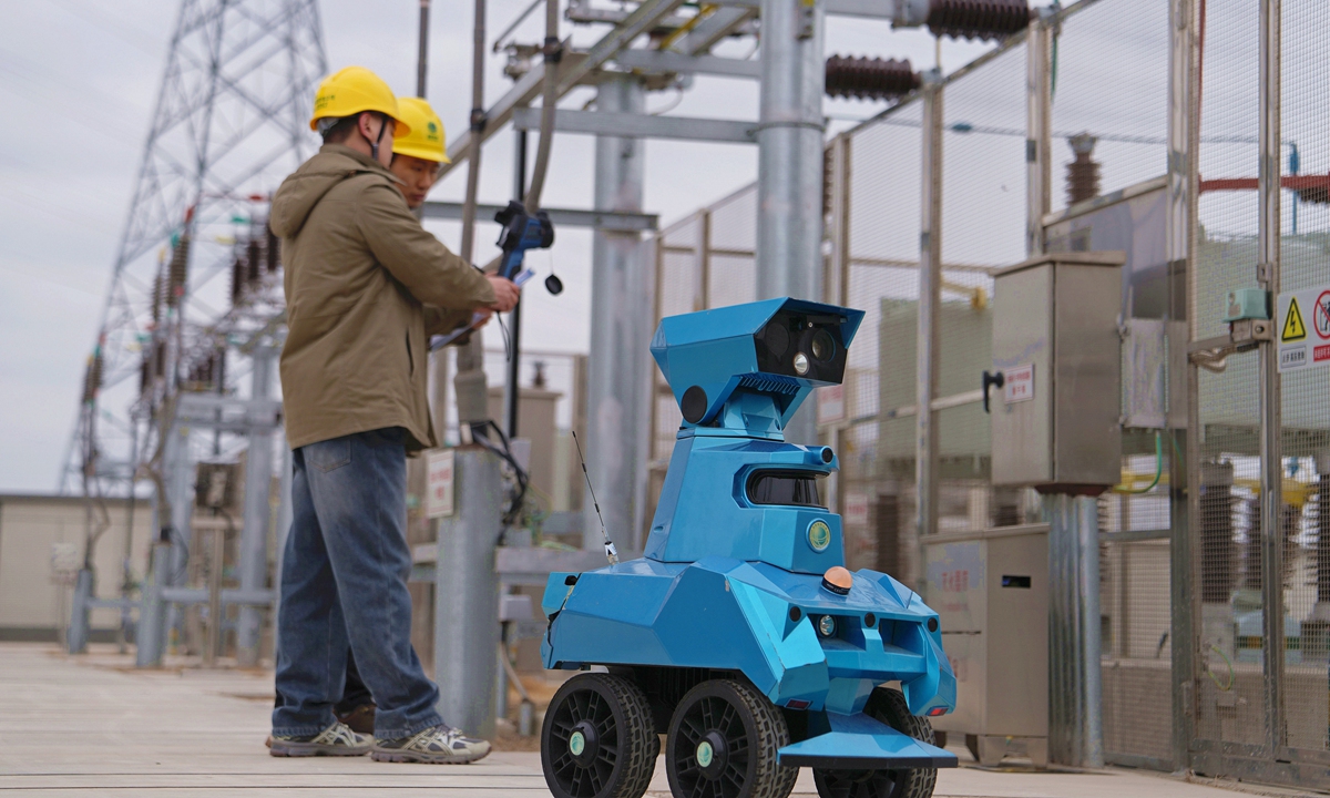 Operation and maintenance personnel conduct joint inspections of power supply equipment with an intelligent inspection robot inside the State Grid Hai'an 220 kV substation to ensure the safe and reliable power supply during the Spring Festival holidays, in Nantong, East China's Jiangsu Province, on February 17, 2026. Photo: VCG