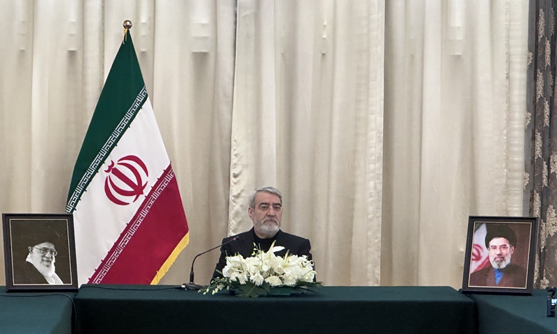 Two framed photographs stand on the table - photo of the late Supreme Leader Ayatollah Ali Khamenei on one side and photo of his successor, Mojtaba Khamenei, the late leader's second son, on the other - as Iranian Ambassador to China Abdolreza Rahmani Fazli met the press at the Iranian Embassy in Beijing on March 9, 2026. Photo: Shen Sheng/GT

