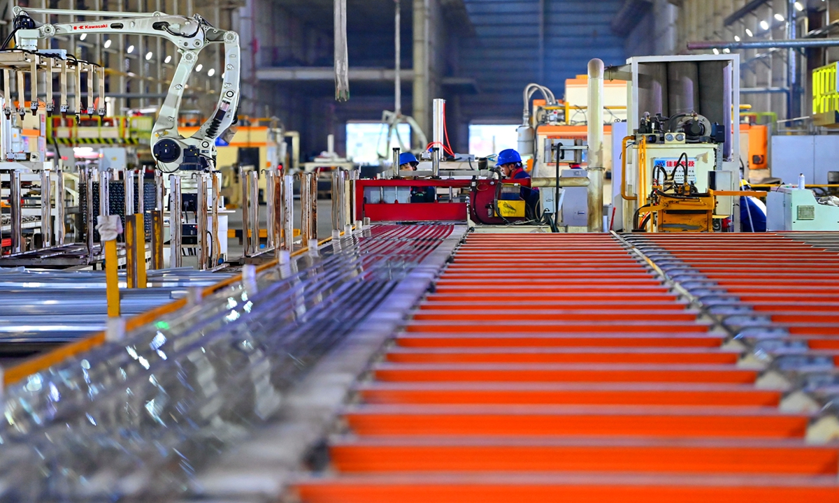Workers process aluminum products on an intelligent production line at a new material base in Fuzhou, East China's Jiangxi Province on March 2, 2026. Photo: VCG