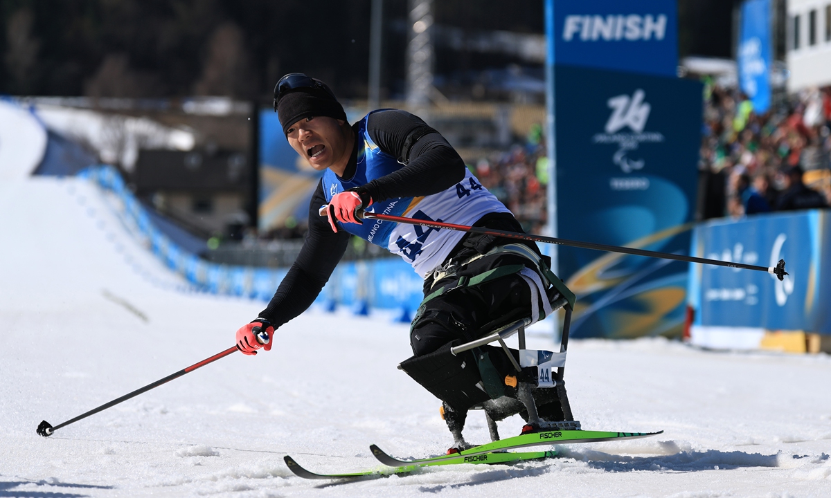 Liu Zixu reacts after crossing the finish line during the men's para biathlon individual sitting on Day 2 of the Milano Cortina 2026 Winter Paralympic Games in Val di Fiemme, Italy on March 8, 2026. Photo: VCG