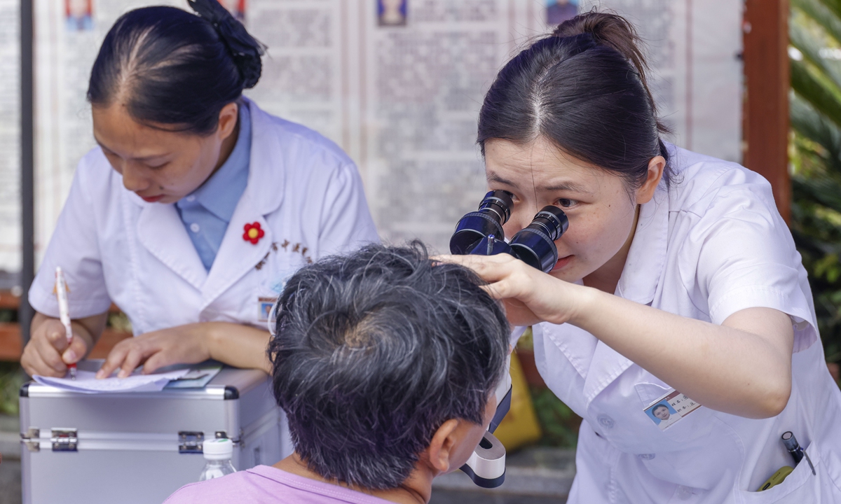 A doctor checks a resident's eyesight in Tongren, Southwest China's Guizhou Province. Photo: VCG