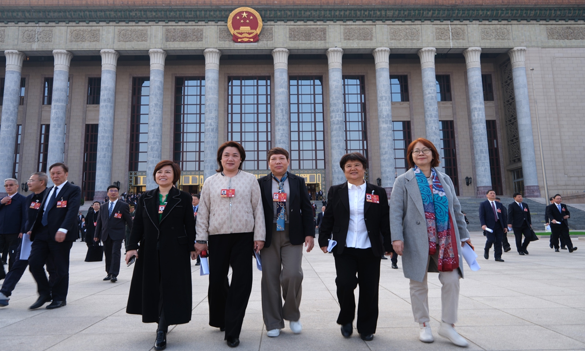 After the third plenary meeting of the fourth session of the 14th National Committee of the Chinese People's Political Consultative Conference (CPPCC) concluded at the Great Hall of the People in Beijing, female members of the CPPCC National Committee walk out of the venue on March 8, 2026, International Women's Day.Photo: VCG