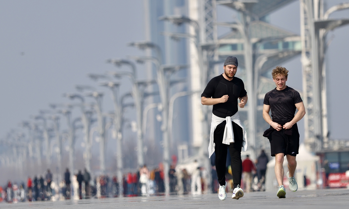 People enjoy the fine spring weather as they exercise at the Olympic Park in Beijing on March 8, 2026, as temperatures in the capital rose to 13 C after a cold snap. Photo: VCG