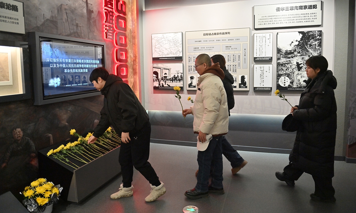 Visitors lay flowers in tribute to fallen compatriots and revolutionary martyrs at an archival exhibition in Changchun, Northeast China's Jilin Province, on December 12, 2025. Photo: VCG