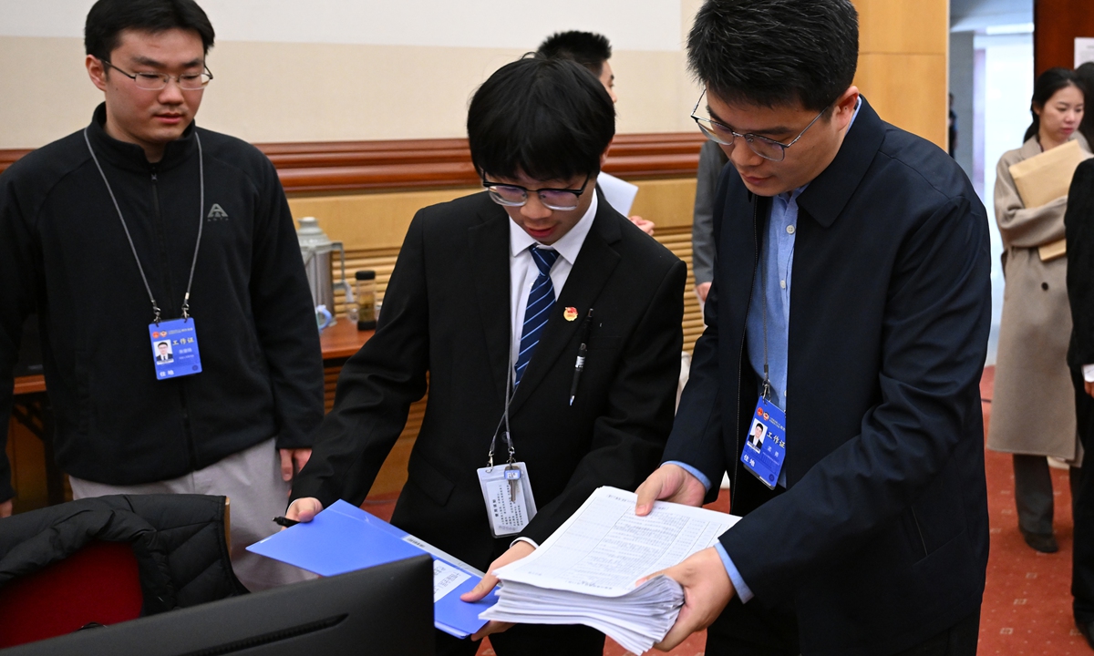 Staff work at the secretariat of the fourth session of the 14th National People's Congress (NPC) in Beijing on March 10, 2026. The secretariat of the session said it has so far received 226 motions and over 7,000 suggestions from Chinese national lawmakers. Photo: VCG