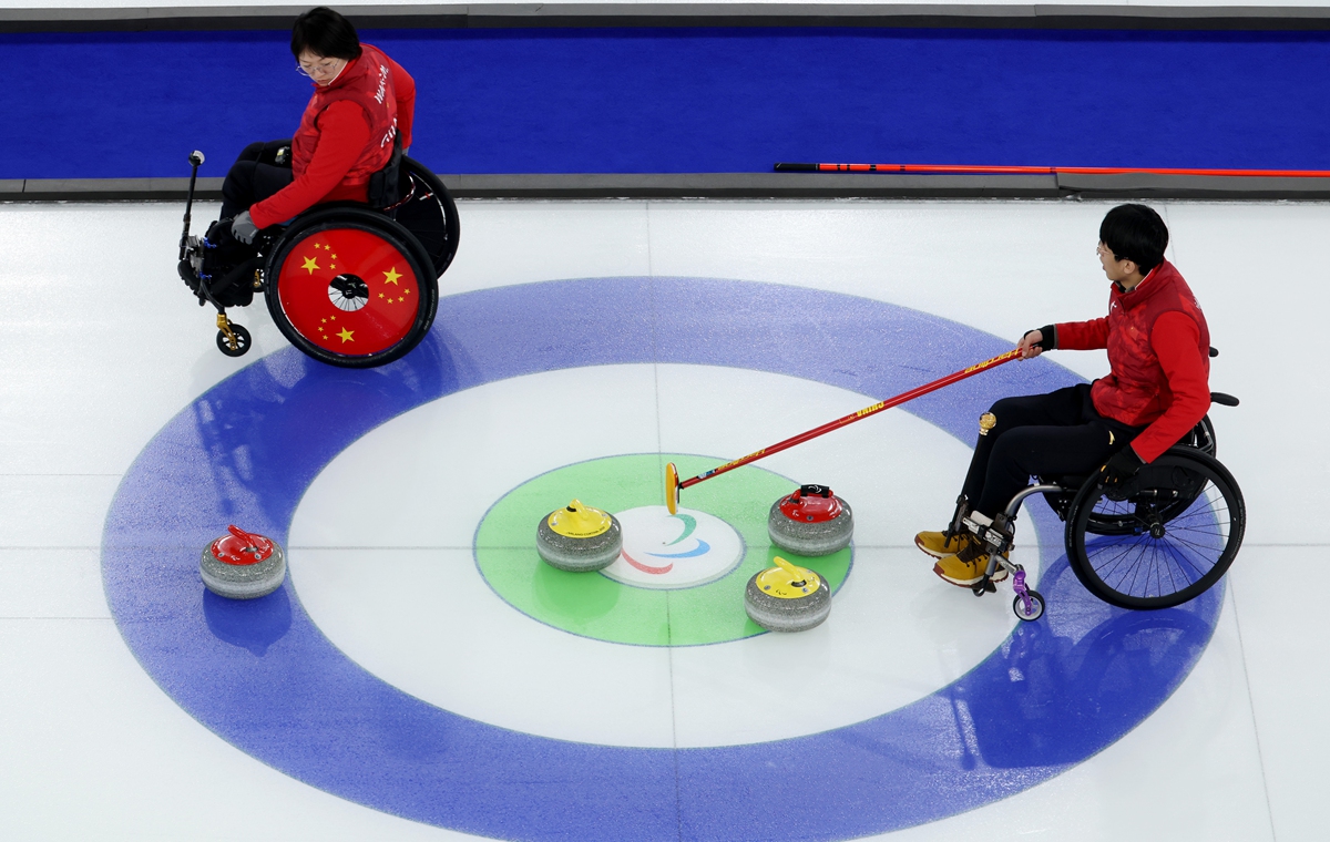 China's Yang Jinqiao (right) and teammate Wang Meng compete during the wheelchair curling mixed doubles gold medal match against South Korea at the Milan-Cortina Winter Paralympic Games in Cortina d'Ampezzo, Italy, on March 11, 2026. Photo: VCG
