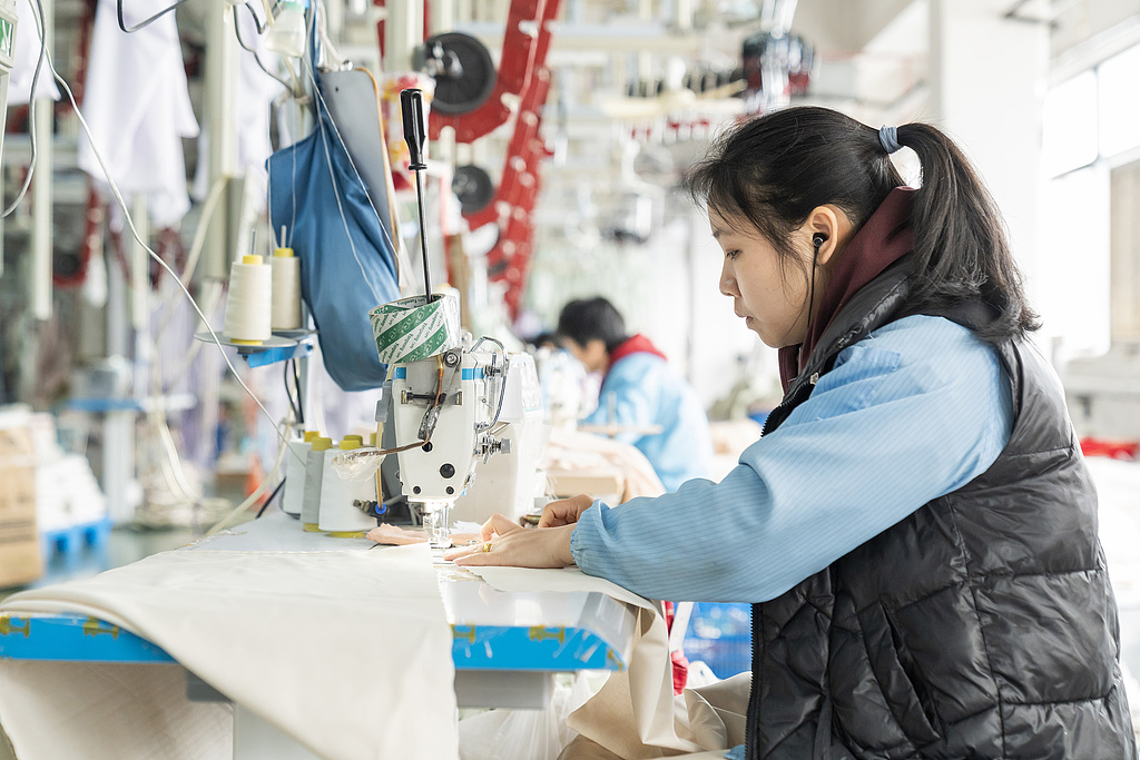 Workers operate machinery at a home textile manufacturing workshop in Chuanjiang town, Tongzhou district, Nantong, East China's Jiangsu Province, on March 15, 2026. By prioritizing upgrades across industry, infrastructure, the environment, and governance, the region has propelled its home textile sector toward intelligent, high-end, and green manufacturing, steadily bolstering its core competitiveness and global influence. Photo: VCG