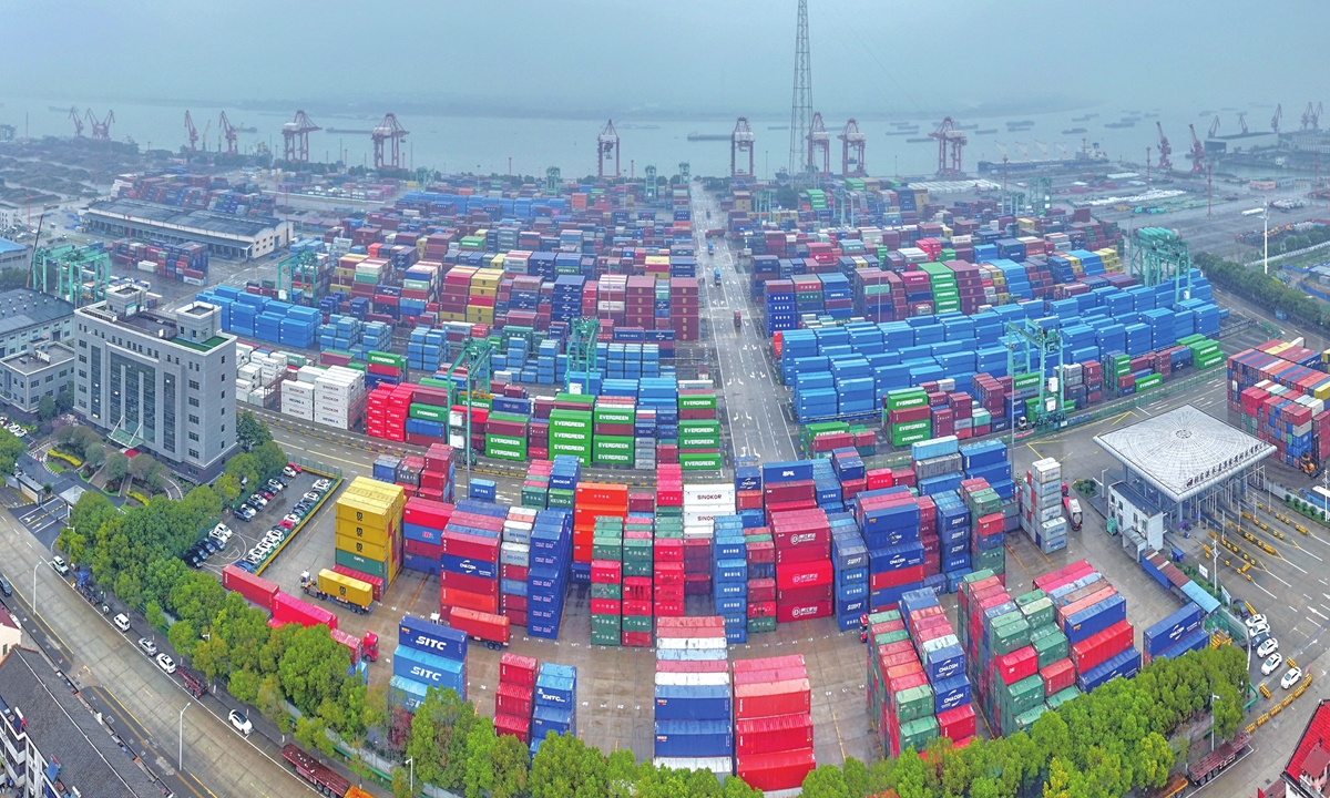 Transport vehicles shuttle between stacks of containers at the container terminal of Zhangjiagang Port, as cargo operations proceed in a busy and orderly manner in Zhangjiagang, East China's Jiangsu Province, on March 16, 2026. Photo: VCG