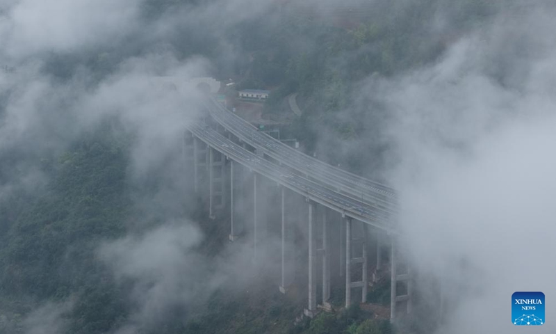 An aerial drone photo taken on March 26, 2026 shows a view of Wulong District shrouded in mist and clouds, southwest China's Chongqing. (Xinhua/Chen Cheng)

