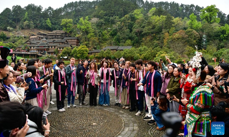 Members of the Whiffenpoofs a cappella choir of Yale University sing a song at Zhaoxing Dong Village of Liping County, southwest China's Guizhou Province, March 23, 2026. The Whiffenpoofs a cappella choir of Yale University visited Liping County in southwest China's Guizhou Province from March 23 to 24 for cultural exchange activities. (Xinhua/Yang Wenbin)

