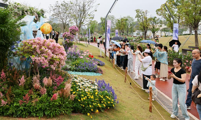 People take photos at a flower show in Shenzhen, south China's Guangdong Province, on March 27, 2026. The 2026 Guangdong-Hong Kong-Macao Greater Bay Area (GBA) Flower Show kicked off on Friday at Bijiashan Sports Park in Shenzhen, and will run until April 6. (Xinhua/Liang Xu)