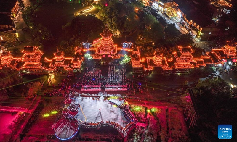 An aerial drone photo taken on March 23, 2026 shows a view of a cultural exchange gala at Zhaoxing Dong Village of Liping County, southwest China's Guizhou Province. The Whiffenpoofs a cappella choir of Yale University visited Liping County in southwest China's Guizhou Province from March 23 to 24 for cultural exchange activities. (Xinhua/Yang Wenbin)

