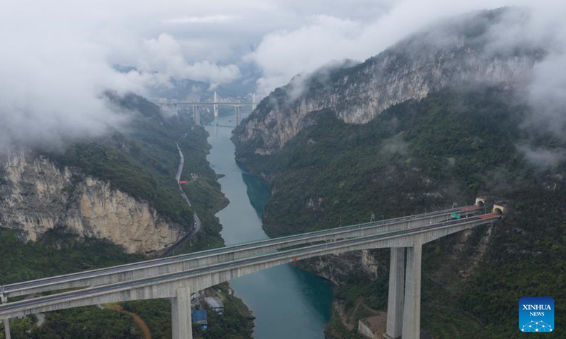 An aerial drone photo taken on March 26, 2026 shows a view of Wulong District shrouded in mist and clouds, southwest China's Chongqing. (Xinhua/Chen Cheng)

