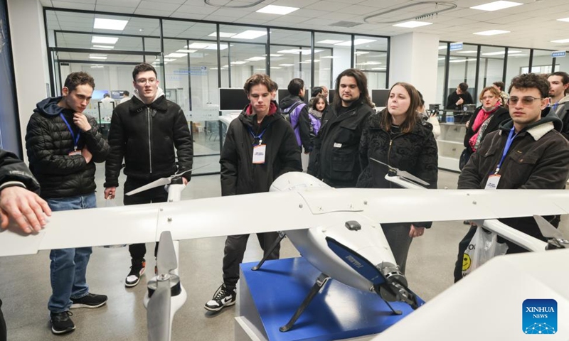 Students from Italy's Jobs Academy Foundation look at a drone displayed at Tianjin Modern Vocational Technology College in north China's Tianjin Municipality, March 14, 2026. (Tianjin Modern Vocational Technology College/Handout via Xinhua)

