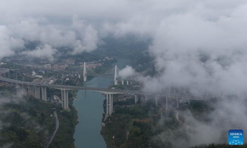 An aerial drone photo taken on March 26, 2026 shows a view of Wulong District shrouded in mist and clouds, southwest China's Chongqing. (Xinhua/Chen Cheng)

