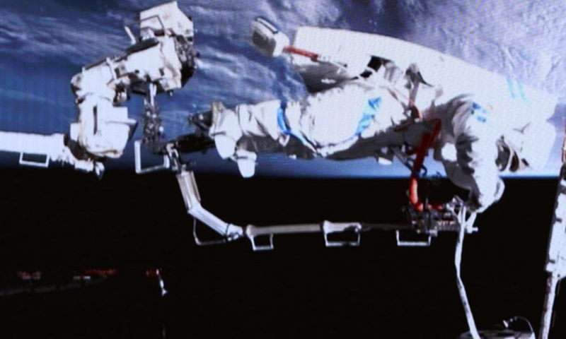 This screen image captured at Beijing Aerospace Control Center on March 16, 2026 shows Shenzhou-21 astronauts performing extravehicular activities outside China's orbiting space station.(Photo by Zhang Fan/Xinhua)
