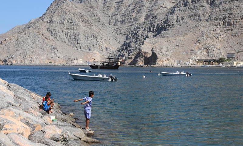 Children play by the shore at Kumzar Village in Oman, Feb. 19, 2025. Kumzar, a remote fishing village in the Musandam Peninsula in northern Oman, located in a sheltered harbor near the strategic shipping lane of the Strait of Hormuz. (Xinhua/Wang Qiang)
