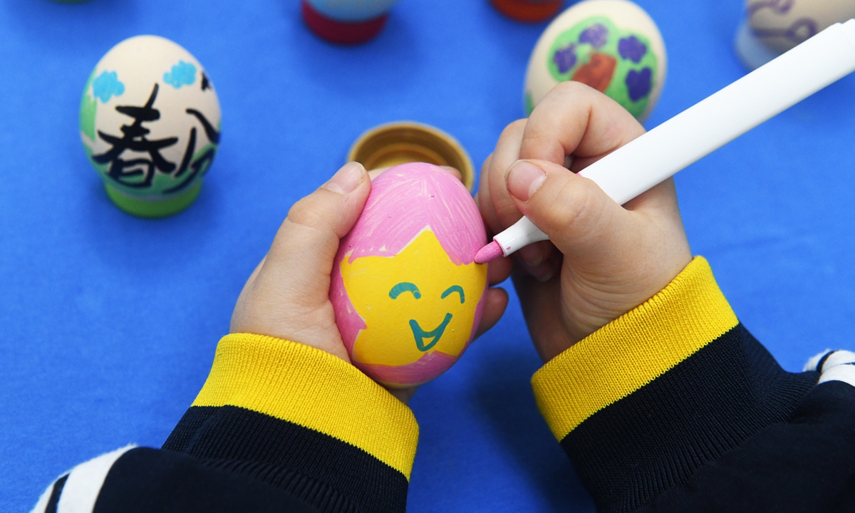 A child from a kindergarten in Xinle, North China's Hebei Province, paints on an eggshell on March 19, 2026, as part of traditional folk activities to mark the Spring Equinox, or Chunfen in Chinese, the fourth solar term in the traditional Chinese calendar, which falls on March 20 this year. Photo: VCG
