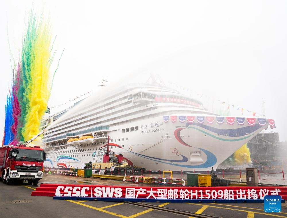 China's second domestically built large cruise ship Adora Flora City is undocked in Shanghai, east China, March 20, 2026. China's second domestically built large cruise ship was undocked in Shanghai on Friday, moving a step closer to trial voyages and final delivery as the country expands its push into the cruise tourism market. The vessel, Adora Flora City, was slowly pulled and guided out of the construction dock by powerful tugboats at Shanghai Waigaoqiao Shipbuilding Co., Ltd., a subsidiary of China State Shipbuilding Corporation (CSSC). It will fully enter the wharf commissioning stage, said the shipbuilder. (Xinhua/Ding Ting)

