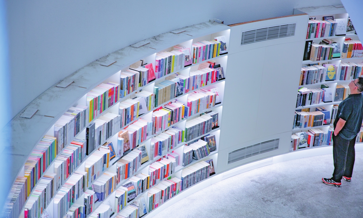 A reader explores books in a bookstore transformed from an abandoned grain warehouse dating back to the 1970s in Kaiping, South China's Guangdong Province, on February 21, 2026. Photos: VCG