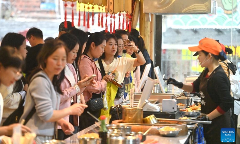People queue up to buy Luosifen at a shop in Liuzhou City, south China's Guangxi Zhuang Autonomous Region, March 14, 2026. (Xinhua/Huang Xiaobang)