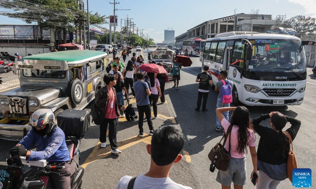 IPeople wait for jeepneys and buses on their way to work as other commuters and public utility drivers and operators hold a transport strike to express their discontent on the continuing oil price hikes at a road in Quezon City, the Philippines, on March 19, 2026. Transport groups on Thursday launched a nationwide transport strike in the Philippines to protest against soaring oil price hikes. Photo: Xinhu