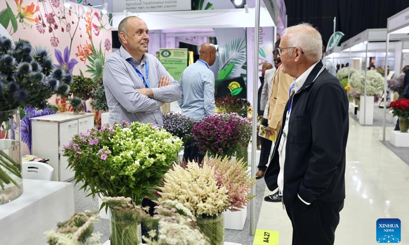 People communicate during the 10th edition of the International Floriculture and Horticulture Trade Fair in Addis Ababa, Ethiopia, March 24, 2026. The 10th edition of the International Floriculture and Horticulture Trade Fair kicked off on Tuesday in Addis Ababa, the capital of Ethiopia, with a call to boost the export of horticultural products. (Xinhua/Geng Xinning)

