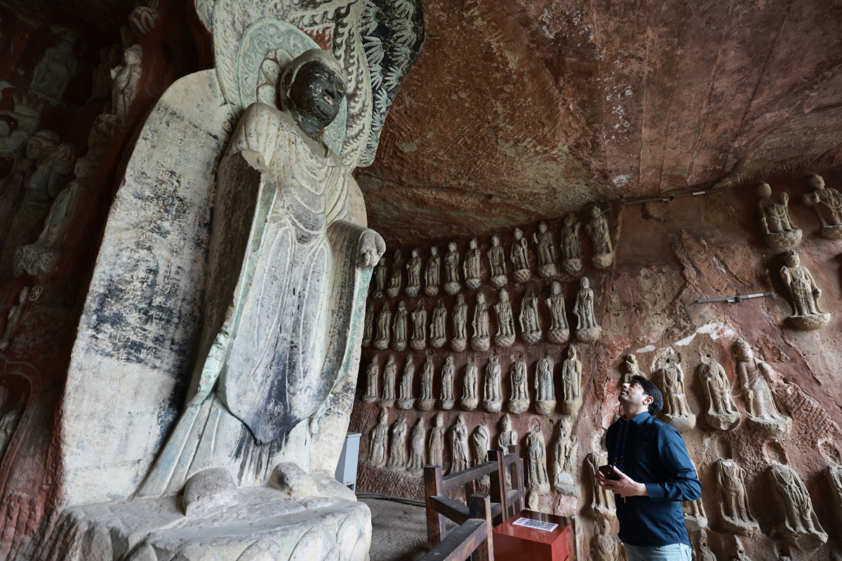 A foreign scholar visits Qianfoya, or 1,000 Buddhas Cliff, in Guangyuan, Sichuan Province, on March 25, 2026. First hewn in the late Northern Wei Dynasty (386-534) and later flourishing in the Tang Dynasty (618-907), Qianfoya is the largest grotto cluster in Sichuan, featuring 950 niches and more than 7,000 statues. Photo: VCG