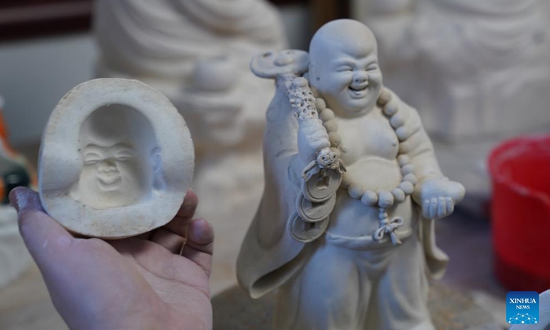 Zeng Rui works on a porcelain sculpture at his studio in Jingdezhen, east China's Jiangxi Province, March 12, 2026. (Xinhua/Zhou Mi)
