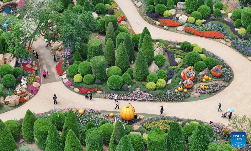 A drone photo taken on March 23, 2026 shows tourists visiting a scenic area in Nanning City, south China's Guangxi Zhuang Autonomous Region. (Photo by Yu Xiangquan/Xinhua)

