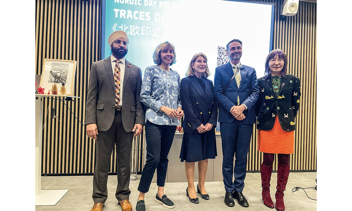 Anu Vuori (second from left), Consul General of Finland in Shanghai, takes a group photo with guests to the Traces of North exhibition held in Shanghai to celebrate the Nordic Day on March 23, 2026. Photo: Feng Yu/GT