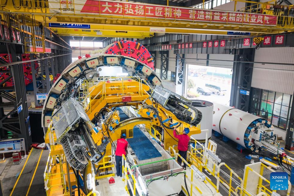 A drone photo taken on March 26, 2026 shows technicians checking the tunnel boring machine (TBM) to be exported to Italy at the second industrial park of China Railway Construction Heavy Industry Corporation Limited in Changsha, central China's Hunan Province. (Xinhua/Chen Sihan)