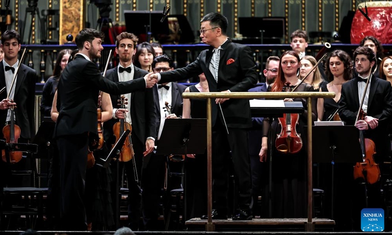 Li Xincao (front R), president of China Conservatory of Music, shakes hands with a Hungarian violinist during a China-Hungary cultural exchange concert in Budapest, Hungary, March 25, 2026. The concert, titled TUTTI -- China-Hungary Cultural Exchange Concert, was held on Wednesday evening at the Liszt Academy of Music in Budapest, featuring a joint symphony orchestra of young musicians from the two countries. (Photo by David Balogh/Xinhua)

