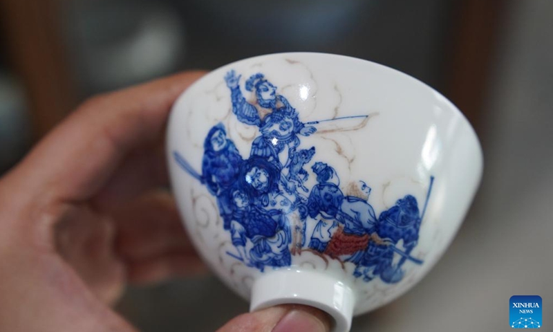 This photo taken on March 11, 2026 shows a blue-and-white porcelain tea set created by Cao Lang and Hu Yunyue at their studio in Jingdezhen, east China's Jiangxi Province.

