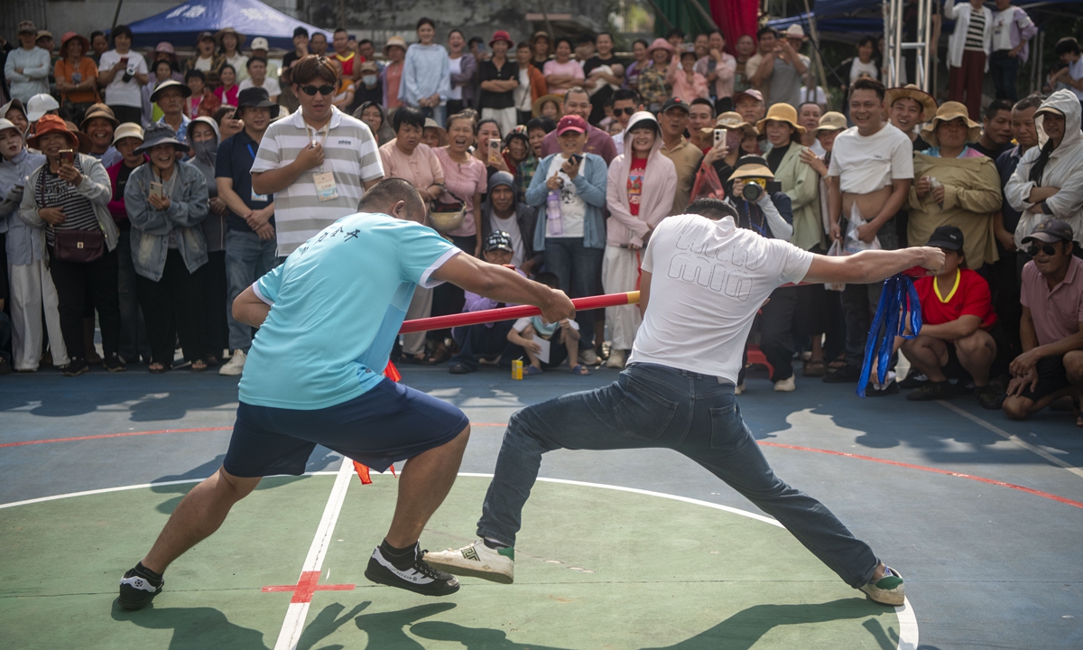 Two men compete in a traditional pole-pushing contest in Qionghai, South China's Hainan Province, on March 29, 2026. The 12th Lady Xian Cultural Festival kicked off in Shibi town, Qionghai on Sunday. Traditional folk competitions including fun sports meets and the turtle-pulling game will be staged, allowing people to fully experience the charm of folk customs and rural sentiments. Photo: VCG