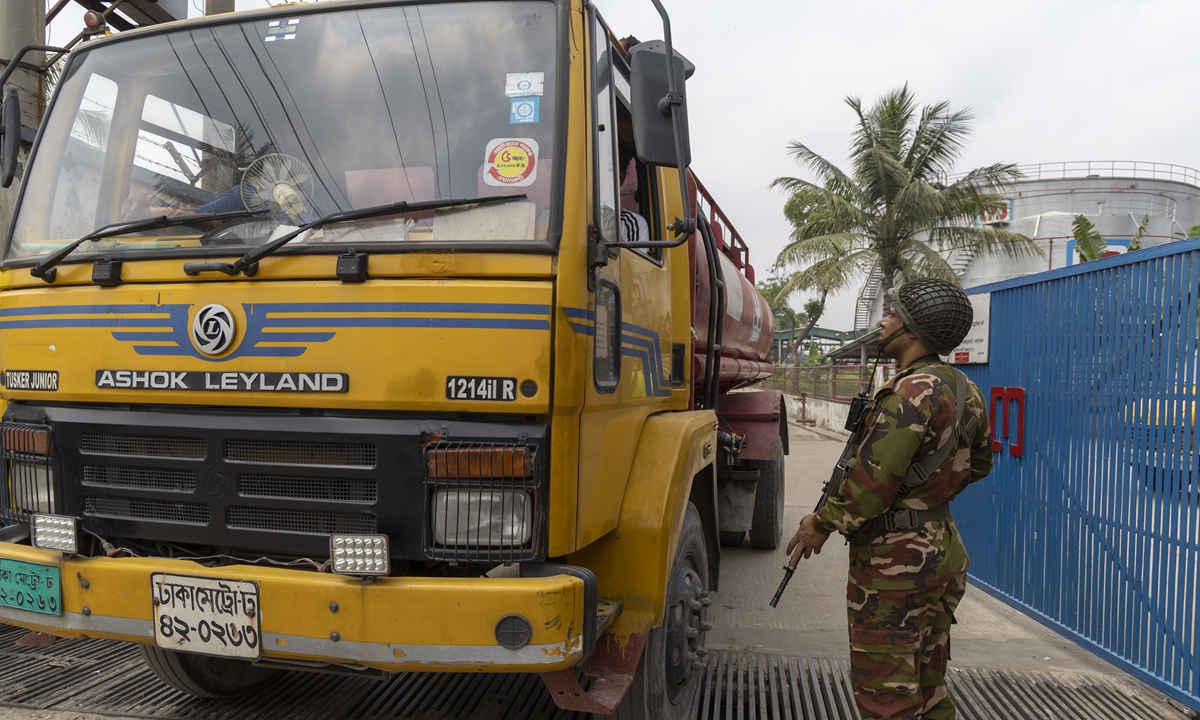A guard is stationed outside a fuel depot to ensure the safe transportation of petrol and diesel on March 29, 2026 in Dhaka, Bangladesh. Members of Border Guard Bangladesh have been deployed at sites across the country to prevent hoarding and ensure supply amid rising prices in the international market, according to media reports. Photo: VCG