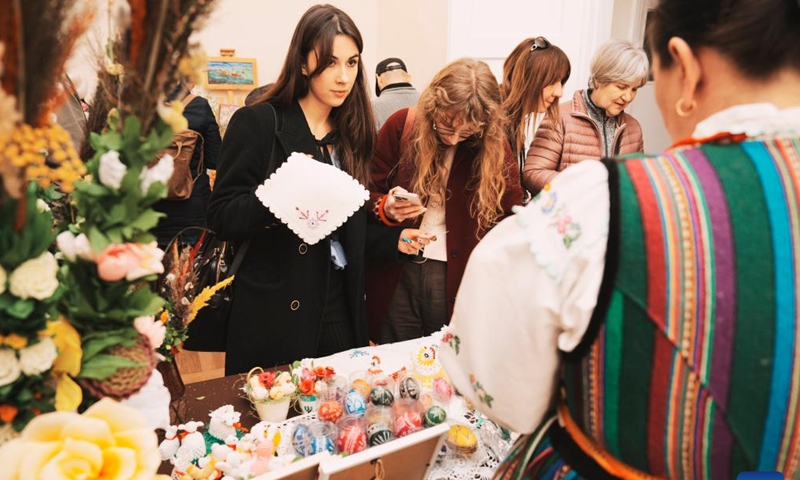 People look at traditional Easter eggs at an Easter fair in Warsaw, Poland, March 28, 2026. Various Polish handicrafts and cultural activities were presented at the event held by the Polish National Institute of Culture and Rural Heritage in Warsaw. (Photo by Jaap Arriens/Xinhua)