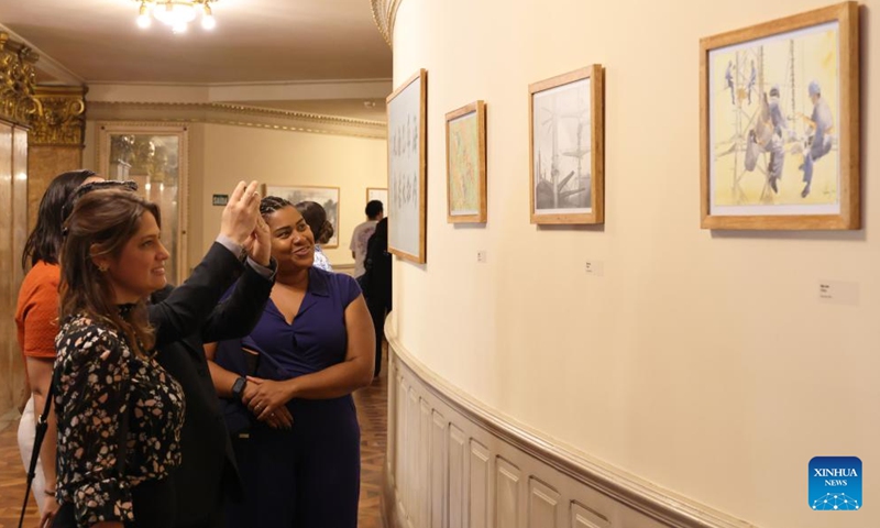 Visitors watch Chinese paintings at a Chinese-Brazilian calligraphy and painting exhibition at the Municipal Theatre of Rio de Janeiro in Brazil, March 25, 2026. The exhibition, themed on Horizons in Dialogue, kicked off in Rio de Janeiro on Wednesday. (Xinhua/Jin Haoyuan)