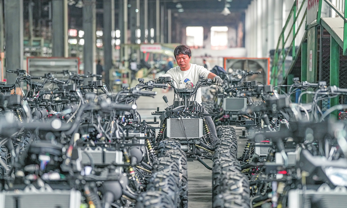 A worker assembles motorcycles on a production line at a manufacturing company in Jinhua, East China's Zhejiang Province, on March 30, 2026. The company is ramping up production to fulfill orders and meet its annual targets. 
Photo: VCG