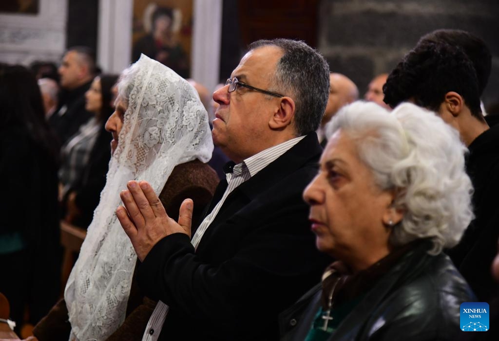 Worshippers pray during Palm Sunday services at a church in Damascus, Syria, on March 29, 2026. Palm Sunday is a Christian feast that falls on the Sunday before Easter and marks the beginning of the Holy Week. (Photo by Ammar Safarjalani/Xinhua)