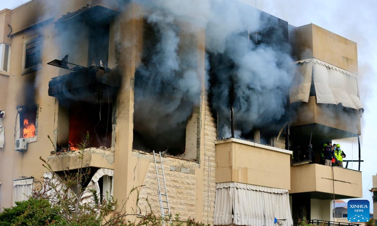 Firefighters extinguish the fire in a building hit by Israeli drone strikes in Haret Saida, Lebanon, March 14, 2026. The U.S.-Israel-Iran conflict entered its 30th day on Sunday. The Middle East is once again caught in a cycle of escalating violence. Civilian casualties are mounting, regional tensions are intensifying, and the risk of a wider war grows by the day. (Photo by Ali Hashisho/Xinhua)
