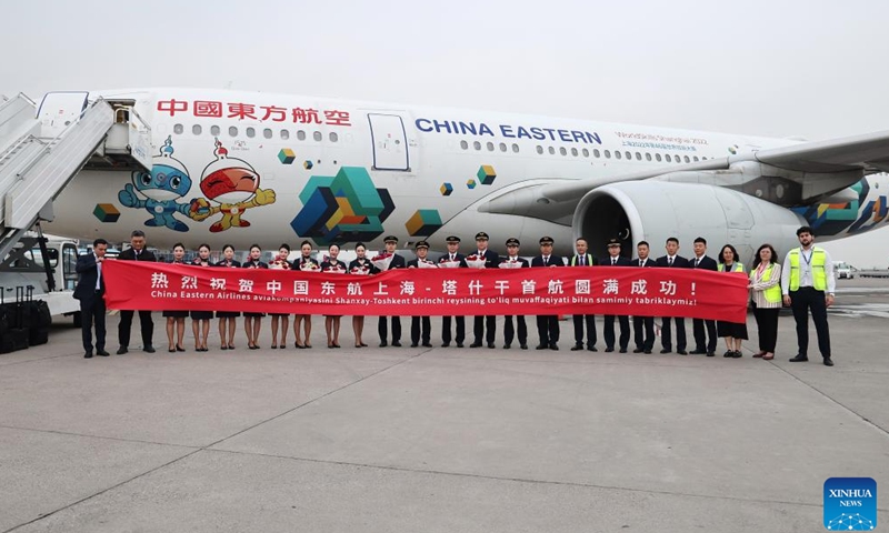 Ground staff members and crew members for the inaugural flight of China Eastern Airlines from Shanghai to Tashkent pose for a group photo in front of the plane in Tashkent, Uzbekistan, March 30, 2026.(Photo by Zafar Khalilov/Xinhua)