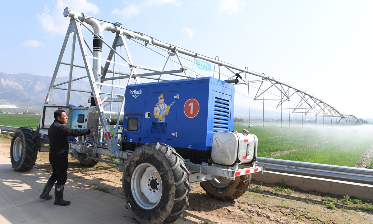 A worker operates an intelligent irrigation and fertilization system at a smart agriculture demonstration zone in Jishan County, North China's Shanxi Province, on March 31, 2026. The zone's smart irrigation and unmanned equipment enhance management efficiency, improving wheat yields and quality for a strong harvest this year. Photo: VCG
