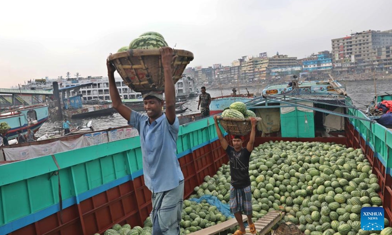 Workers unload watermelons from boats at Sadarghat in Dhaka, Bangladesh, March 30, 2026. (Photo by Habibur Rahman/Xinhua)

