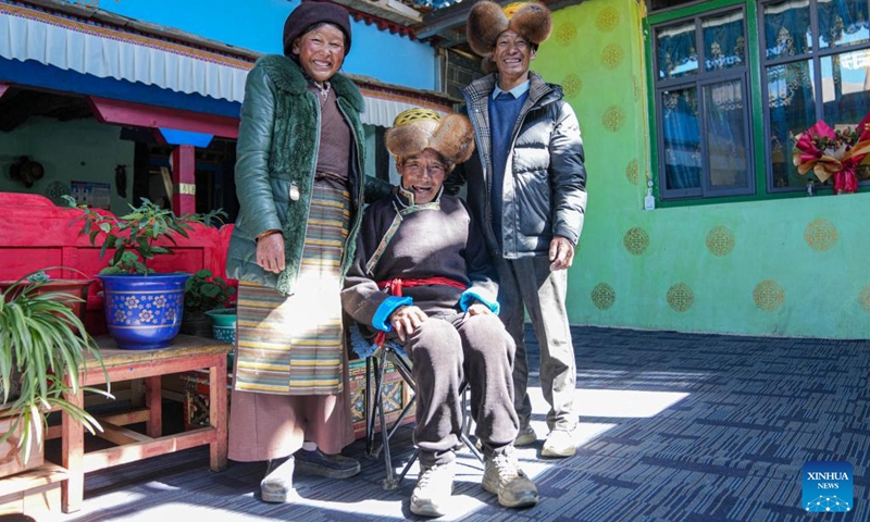 Padma Tashi (C) sits for a group photo with his daughter and son-in-law at home in Zhanang County, southwest China's Xizang Autonomous Region, March 26, 2026. (Xinhua/Jigme Dorje)