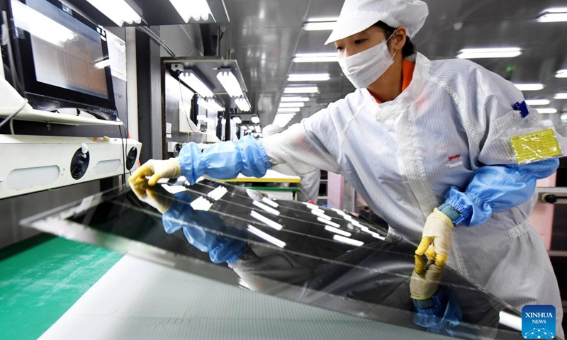 A worker produces glass substrates at the production workshop of WG Tech, an optoelectronic company, in Xinyu City, east China's Jiangxi Province, on March 5, 2026. (Photo by Ling Houxiang/Xinhua)

